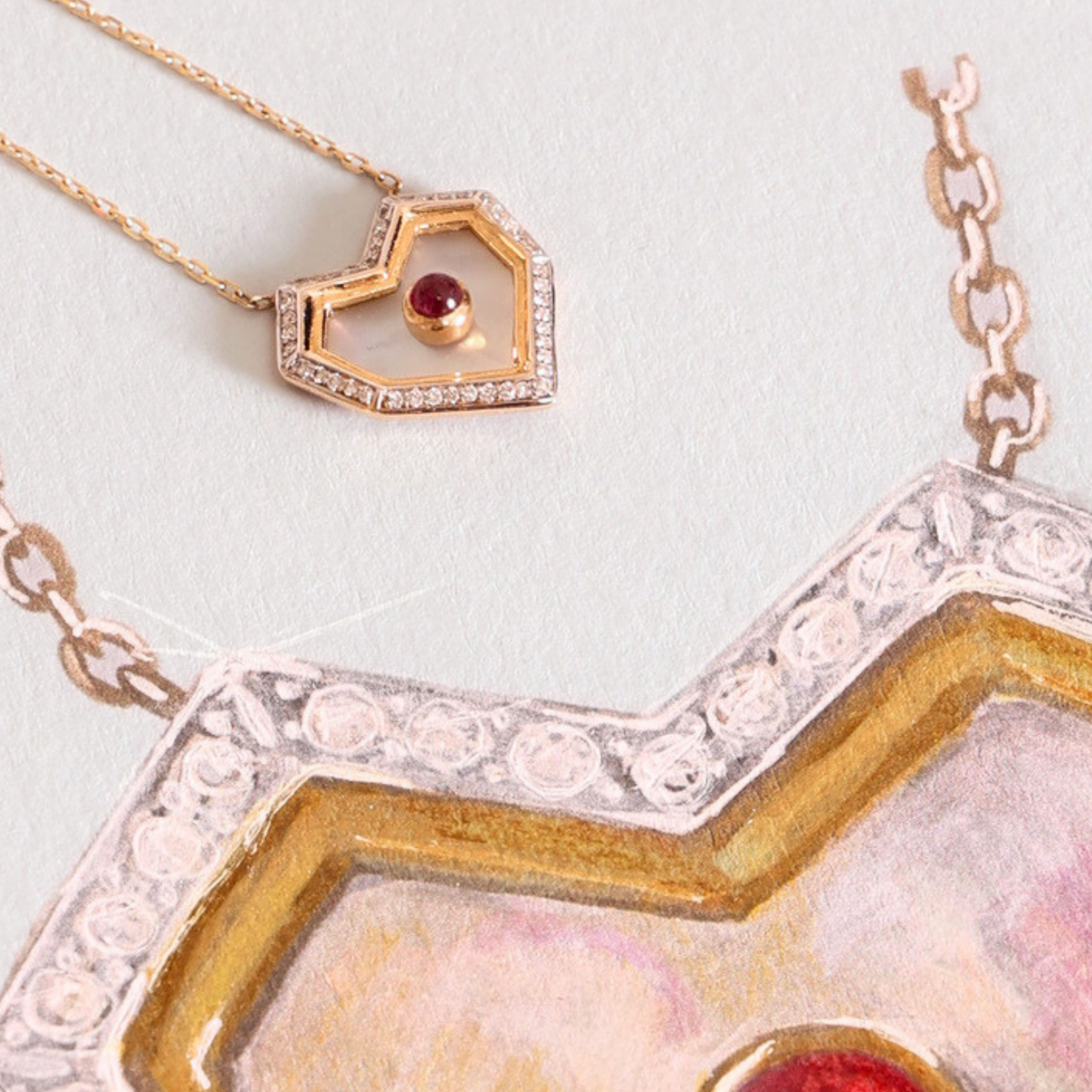 A close-up of jewelry featuring a heart-shaped pendant necklace with a gold-toned open heart, small clear stones, and a red gemstone, alongside a larger matching heart-shaped piece with a silver-toned floral border and red stone.
